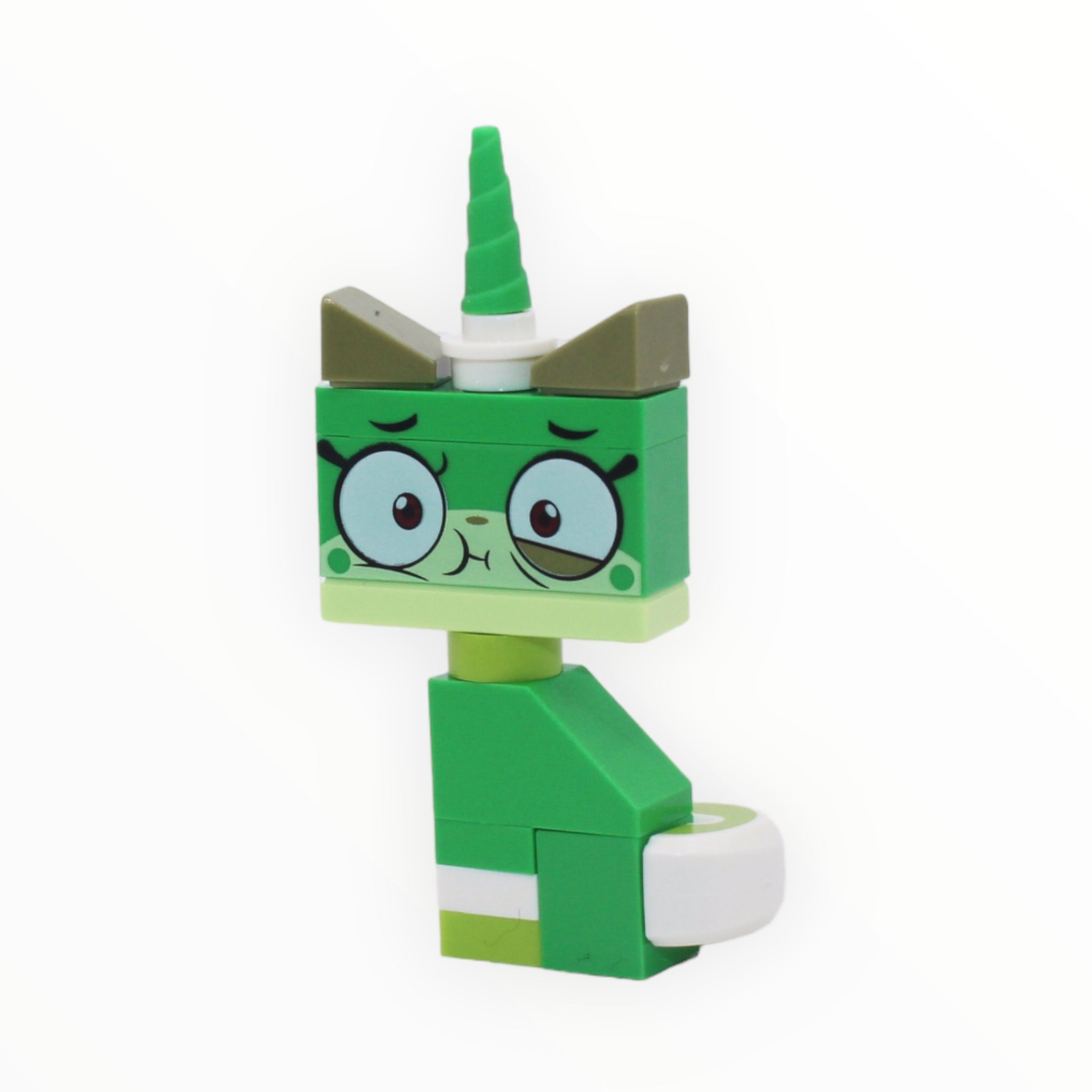a green toy clock on a green wall