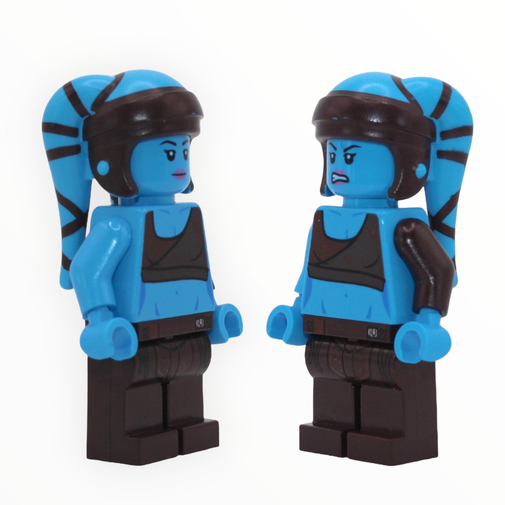 a couple of parking meters in front of a wall