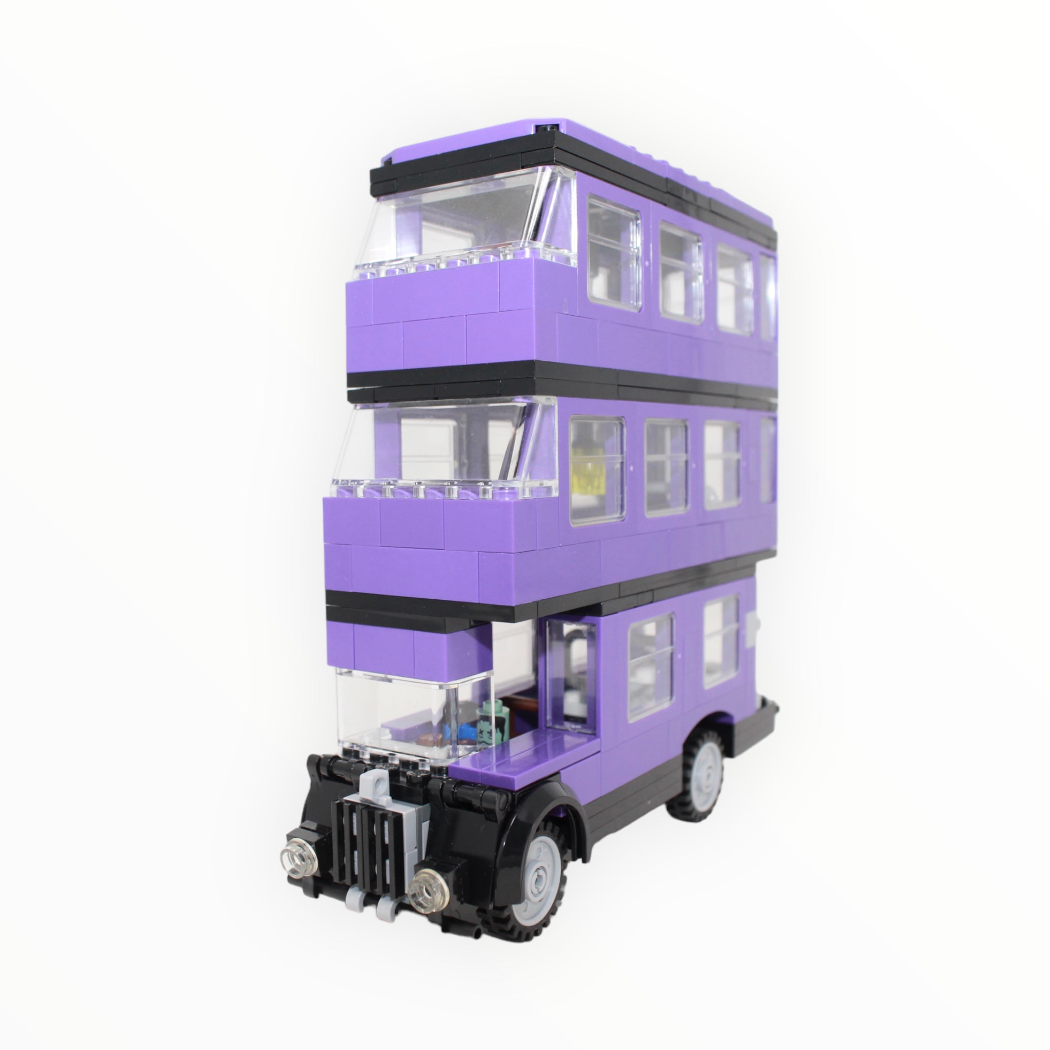 a pink double decker bus parked in a parking lot