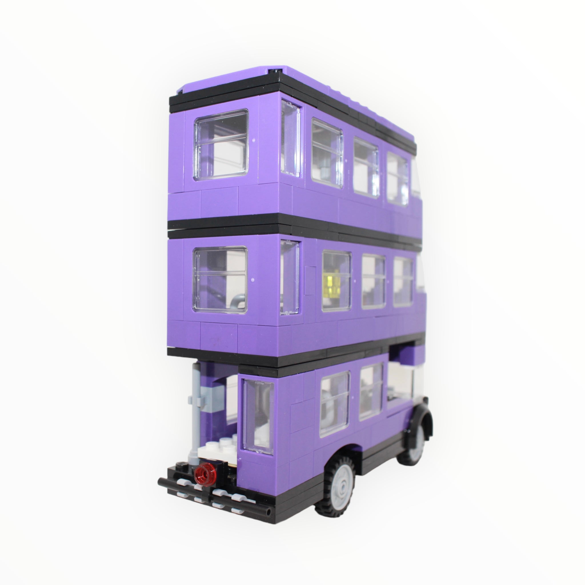 a triple decker bus parked in front of a building